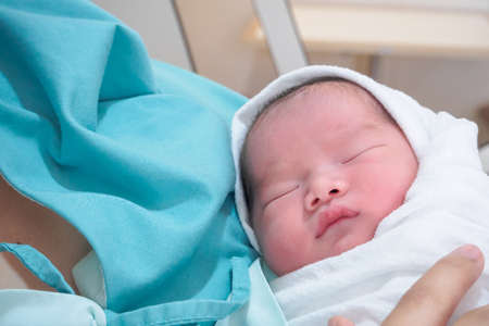 Happy Mother and Newborn Baby after labor at the hospitalの写真素材