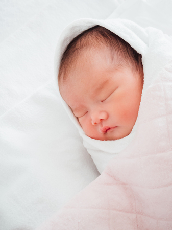 Newborn baby girl sleepingの写真素材