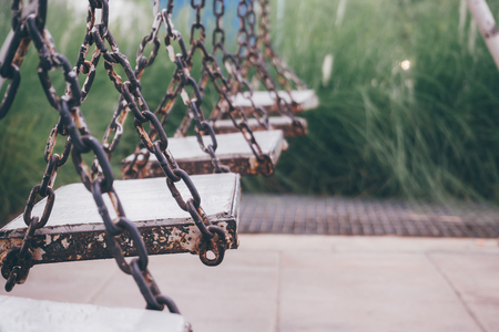 old wood swing in playground parkの写真素材