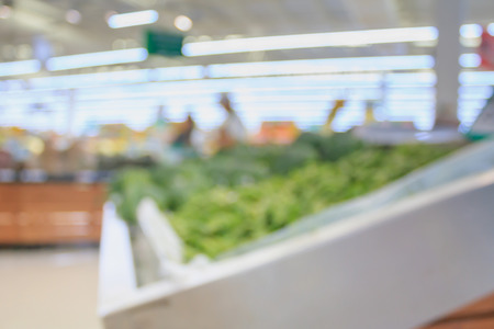 Supermarket with fresh food abstract blurred background with bokeh lightの写真素材