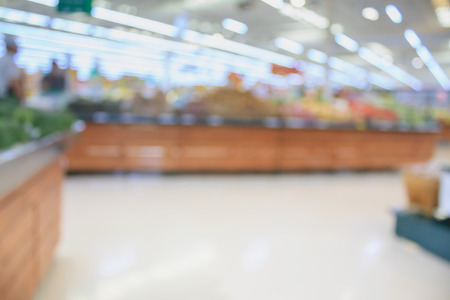 Supermarket with fresh food abstract blurred background with bokeh lightの写真素材