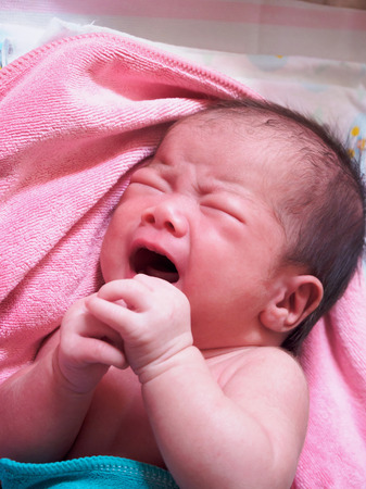 newborn baby cryingの写真素材