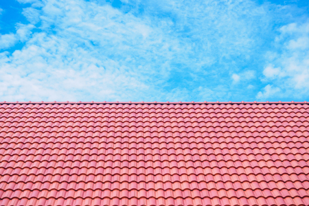 roof tiles patterns with blue sky and cloudsの写真素材