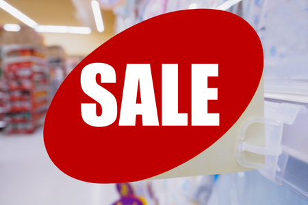 Supermarket sale sign display on shelves in department retail storeの写真素材