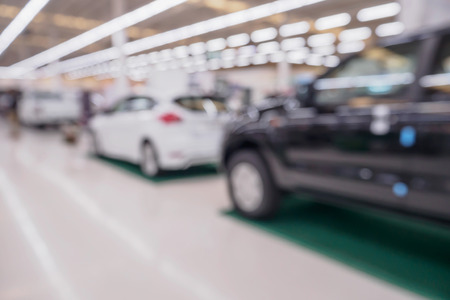 blur row of new car at car showroom dealership abstract defocused backgroundの写真素材