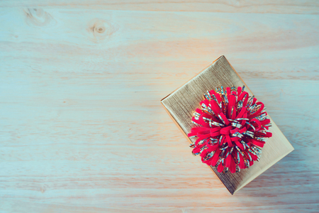 golden gift box on wood table for christmas backgroundの写真素材