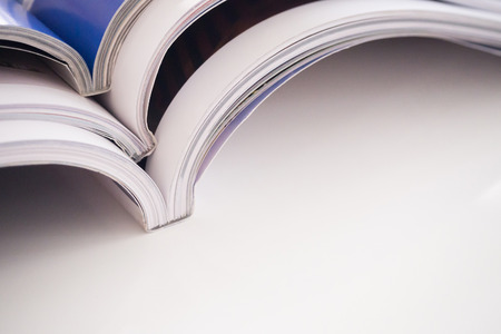pile of magazines stack on white table in living room, close upの写真素材
