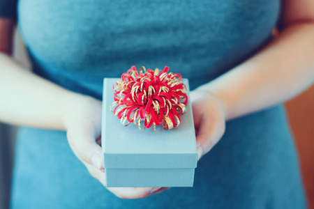 Woman holding and giving gift box, vintage toneの写真素材