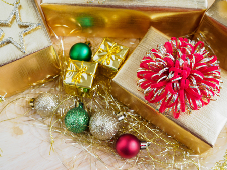 golden gift box with christmas ornaments on wood table for christmas backgroundの写真素材