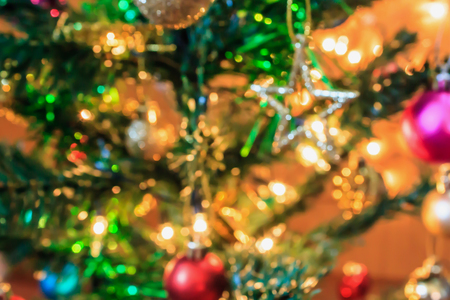 Abstract Christmas tree with decorations bokeh light blur backgroundの写真素材