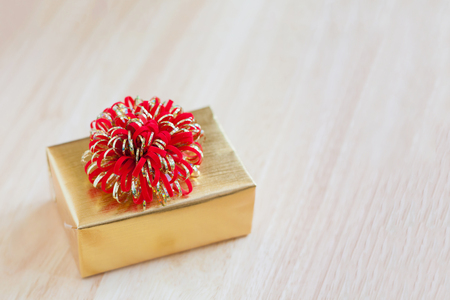 golden gift box on wood table for christmas backgroundの写真素材