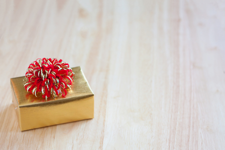 golden gift box on wood table for christmas backgroundの写真素材