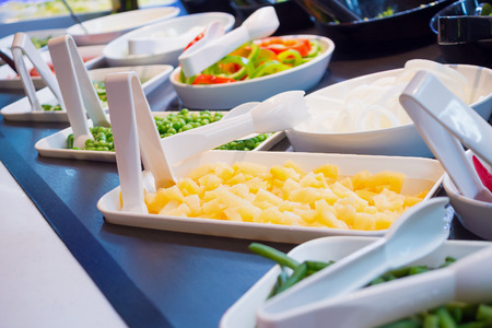 fresh vegetables slice on salad bar buffet shelves in restaurant, healthy foodの写真素材