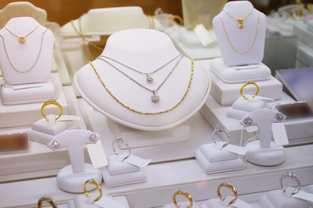 jewelry diamond gold shop with rings and necklaces luxury retail store window display showcaseの写真素材
