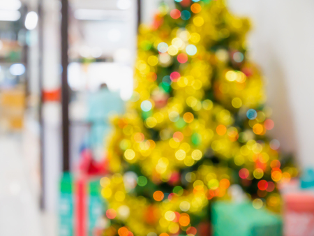 Christmas tree decorated with lights abstract blur background with bokehの写真素材