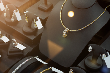 jewelry diamond gold shop with rings and necklaces luxury retail store window display showcaseの写真素材