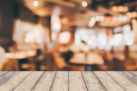 Restaurant table in cafe or coffee shop interior with people abstract defocused blur backgroundの写真素材
