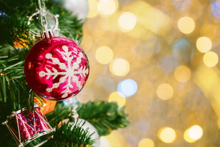 Decorated Christmas tree with colorful bauble on sparkling bokeh light blurred backgroundの写真素材