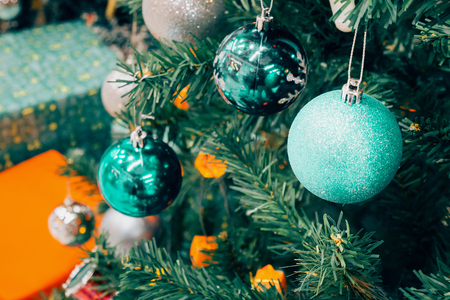 Decorated Christmas tree with colorful bauble on sparkling bokeh light blurred backgroundの写真素材