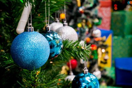Decorated Christmas tree with colorful bauble on sparkling bokeh light blurred backgroundの写真素材