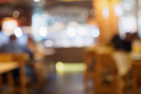 Blur customers in cafe restaurant or coffee shop abstract background with bokeh lightの写真素材