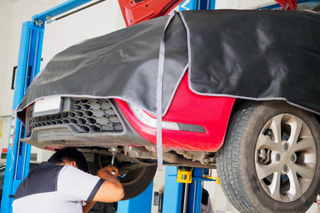Red car in auto service centre station for repair and maintenanceの写真素材