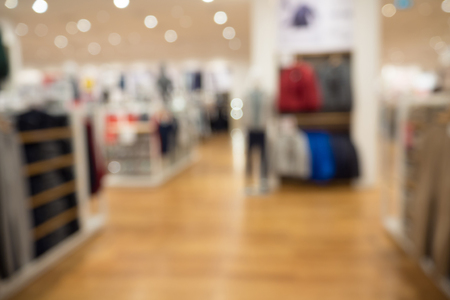 clothing store in shopping mall boutique shop interior blur defocused backgroundの写真素材