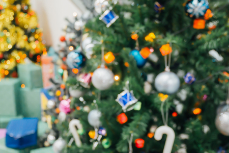 Christmas tree decorated with lights abstract blur background with bokehの写真素材