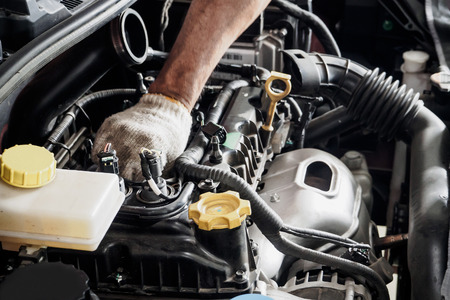 Mechanic with wrench working and repair car engine in car service centreの写真素材