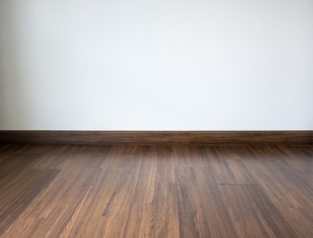 Empty room with laminate floor and white wall backgroundの写真素材
