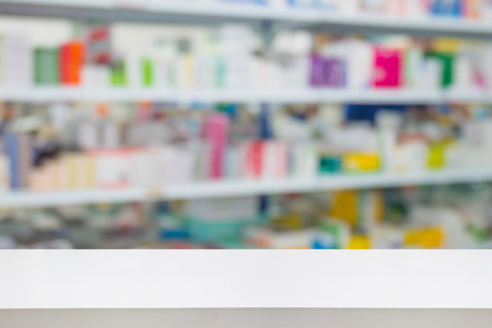 pharmacy counter drugstore shop interior with medicines vitamins supplement and healthcare product for healthy on shelves blur backgroundの写真素材