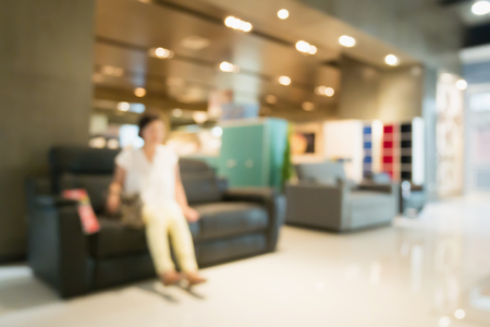 Abstract blur sofa in furniture store shop interior with bokeh light background for montage product displayの写真素材
