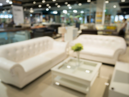 Abstract blur sofa in furniture store shop interior with bokeh light background for montage product displayの写真素材