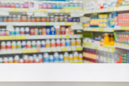 pharmacy counter drugstore shop interior with medicines vitamins supplement and healthcare product for healthy on shelves blur backgroundの写真素材