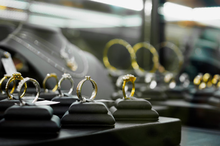 Jewelry diamond rings and necklaces show in luxury retail store window display showcaseの写真素材