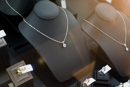 jewelry diamond gold shop with rings and necklaces luxury retail store window display showcaseの写真素材