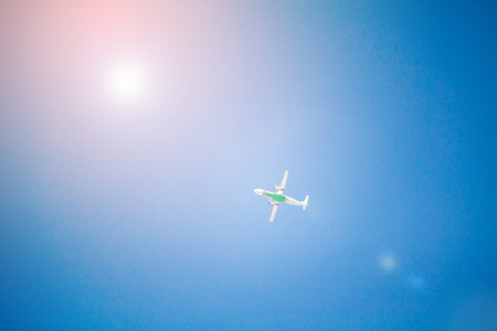 Airplane flying with blue skyの写真素材