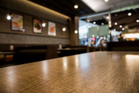 Abstract cafe coffee shoop restaurant table with blur background with bokeh lightの写真素材
