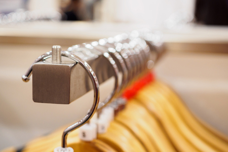 Close up clothes hanging on rack in fashion boutique storeの写真素材