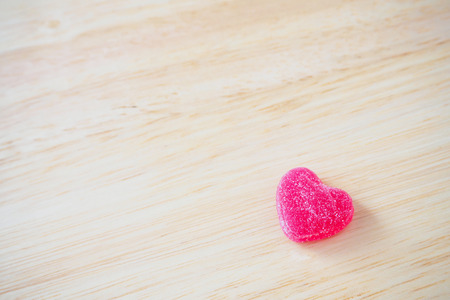 pink hearts candy on wood for valentines backgroundの写真素材