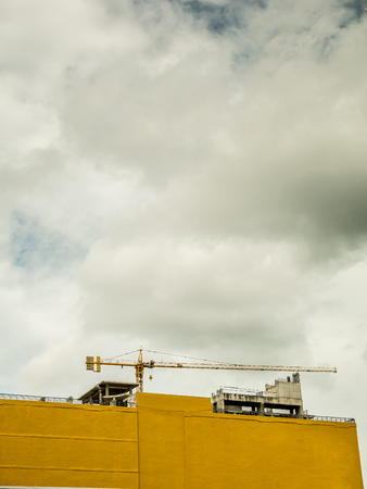 Construction tower crane at building siteの写真素材