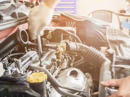 Mechanic with wrench working and repair car engine in car service centreの写真素材