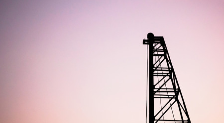 Silhouette pile driver at construction siteの写真素材