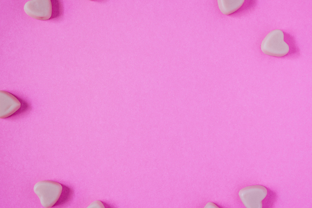 valentine candy hearts shape on pink backgroundの写真素材