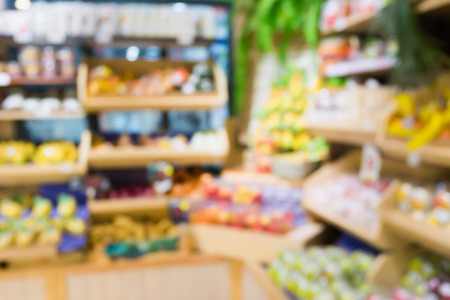 Supermarket grocery store with fruit and vegetable on shelves blurred backgroundの写真素材