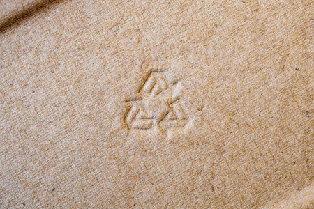 recycle sign on brown paper texture backgroundの写真素材