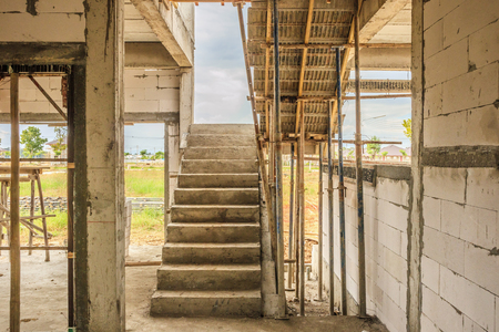 New house construction interior with concrete staircase at building siteの写真素材