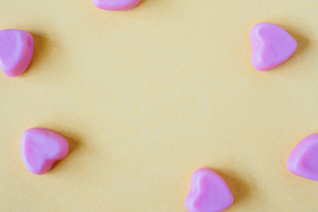 Valentines day background with heart shape candy on yellow backgroundの写真素材
