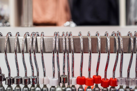 Close up clothes hanging on rack in fashion boutique storeの写真素材
