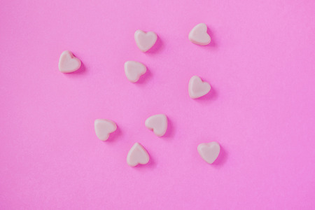 valentine candy hearts shape on pink backgroundの写真素材